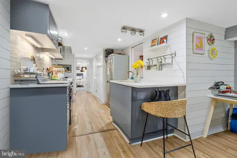 a kitchen with stainless steel appliances kitchen island granite countertop a sink and cabinets