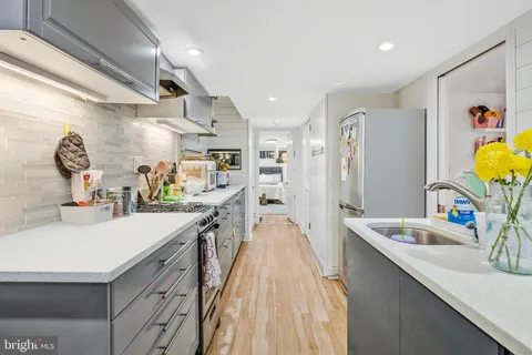 a kitchen with a sink appliances and a counter top space
