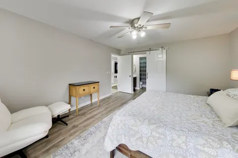 a spacious bedroom with a bed and a couch