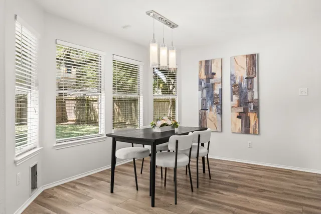 a view of a dining room with furniture windows and wooden floor