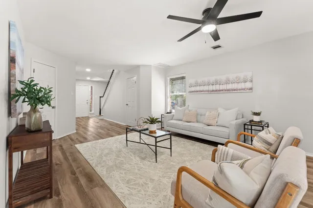 a living room with furniture and a potted plant