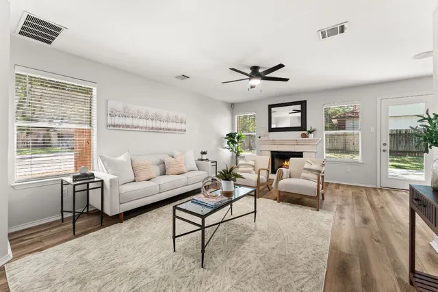 a living room with furniture a fireplace and a table