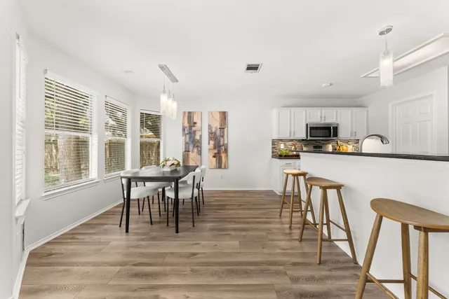 a view of a dining room with furniture and wooden floor