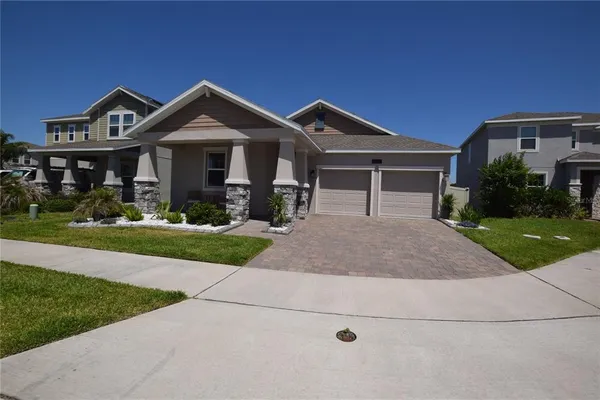 a front view of house with yard and green space