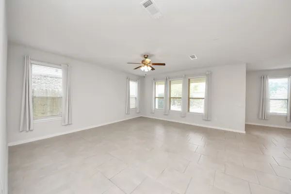 wooden floor in an empty room with a kitchen