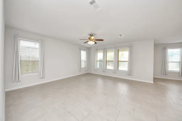wooden floor in an empty room with a kitchen