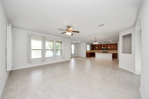 a view of a kitchen with a sink and a chandelier fan