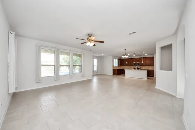a view of a kitchen with a sink and a chandelier fan