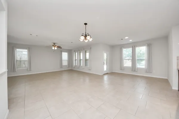 a view of a kitchen with refrigerator and windows