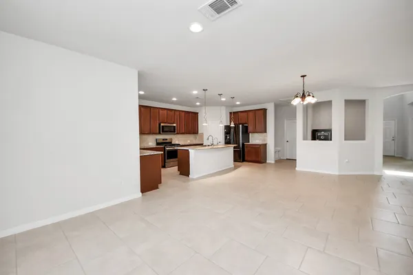 a view of kitchen with refrigerator and window