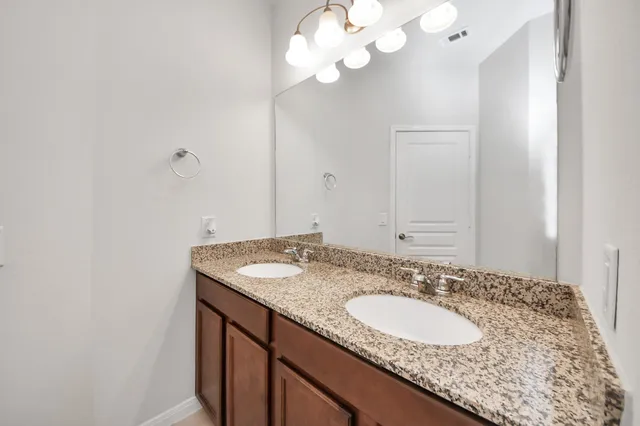 a view of an empty room with a window and a ceiling fan