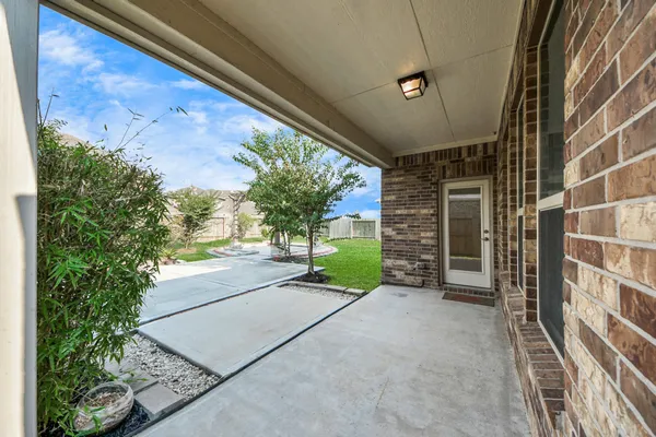 a view of a hallway with a white walls and stairs