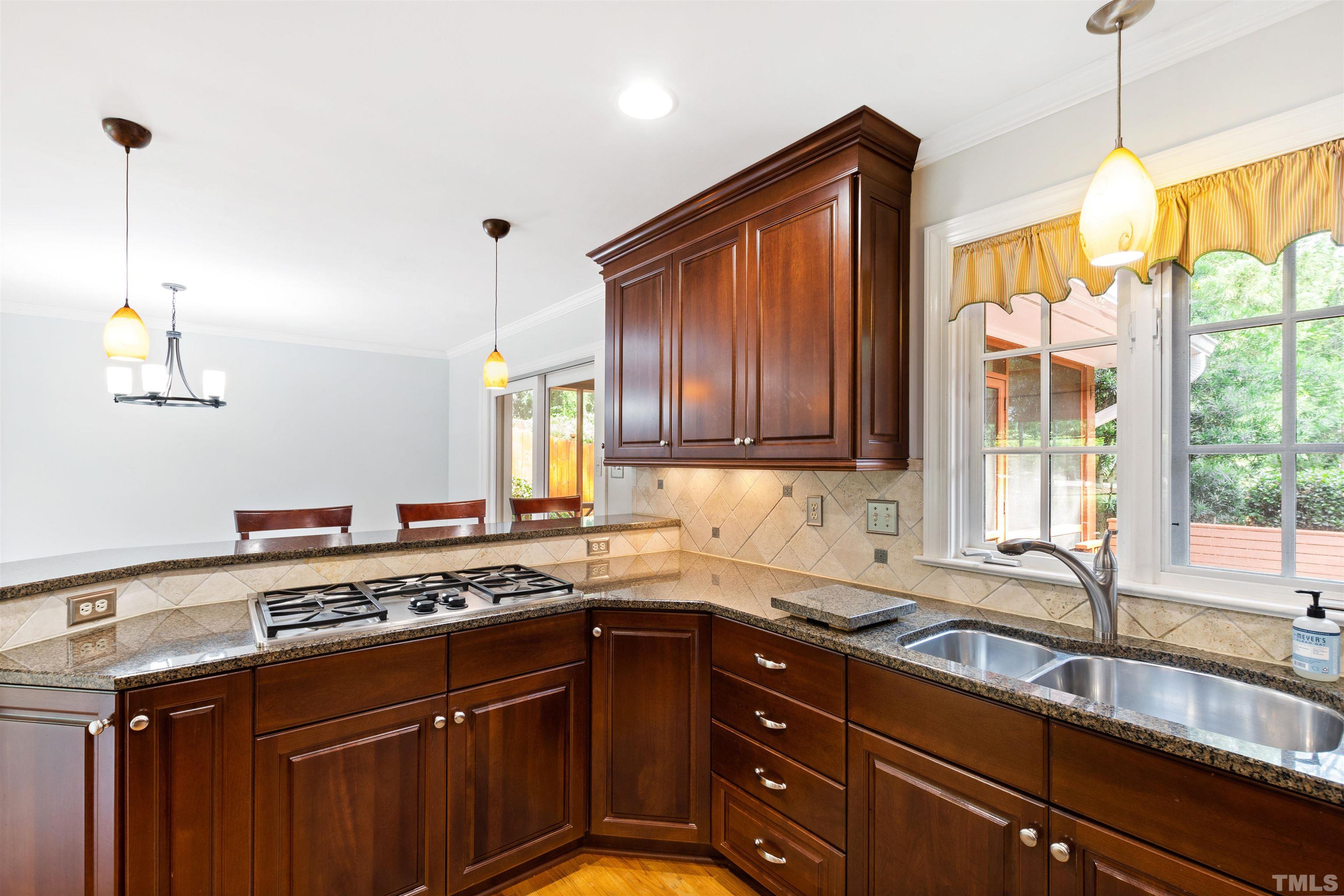 1320 Diehl Street Raleigh, NC 27608 - Photo 13 of 47 a kitchen with stainless steel appliances granite countertop a sink a stove and a microwave