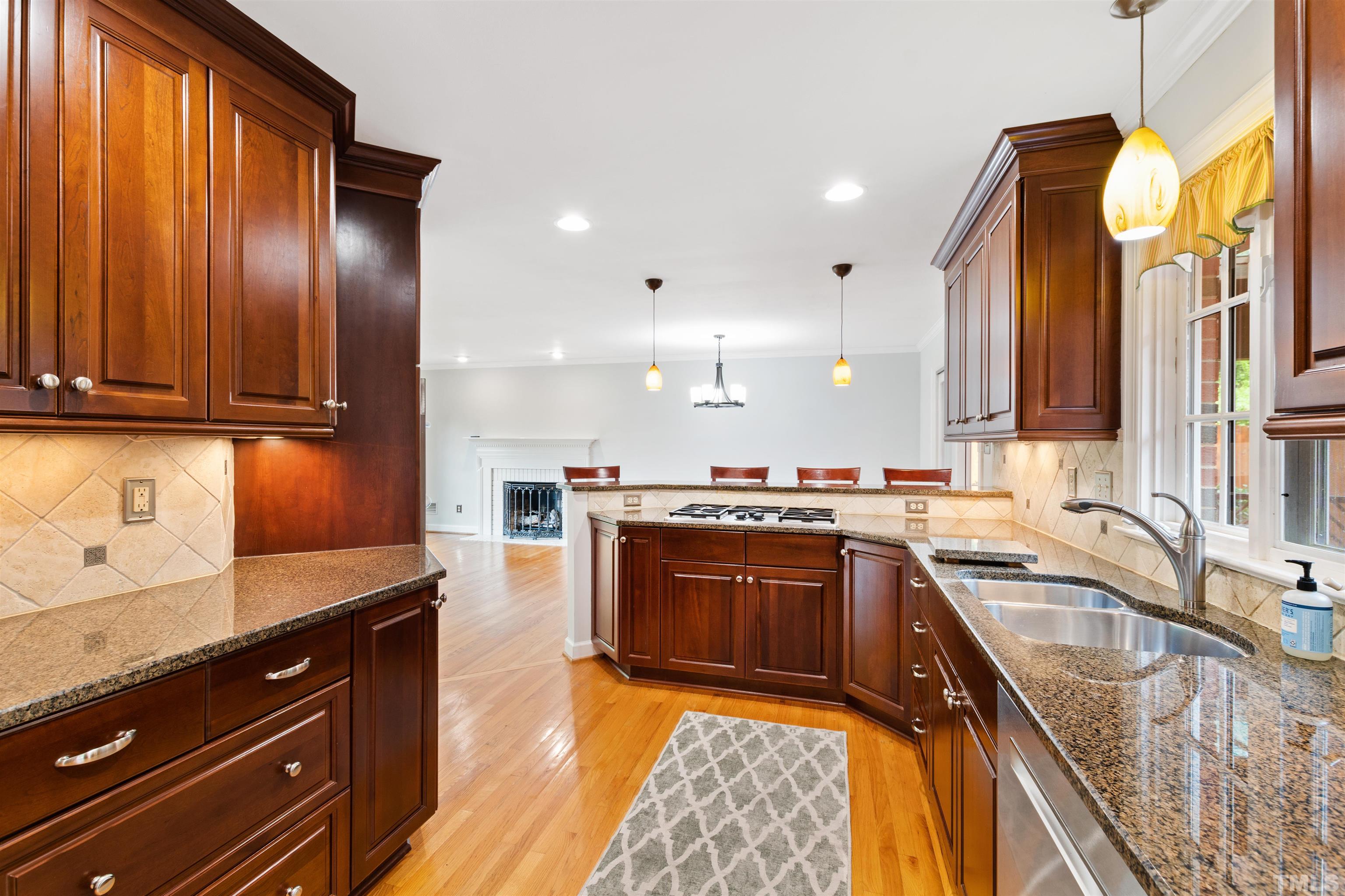 1320 Diehl Street Raleigh, NC 27608 - Photo 14 of 47 a large kitchen with stainless steel appliances granite countertop a sink stove and refrigerator