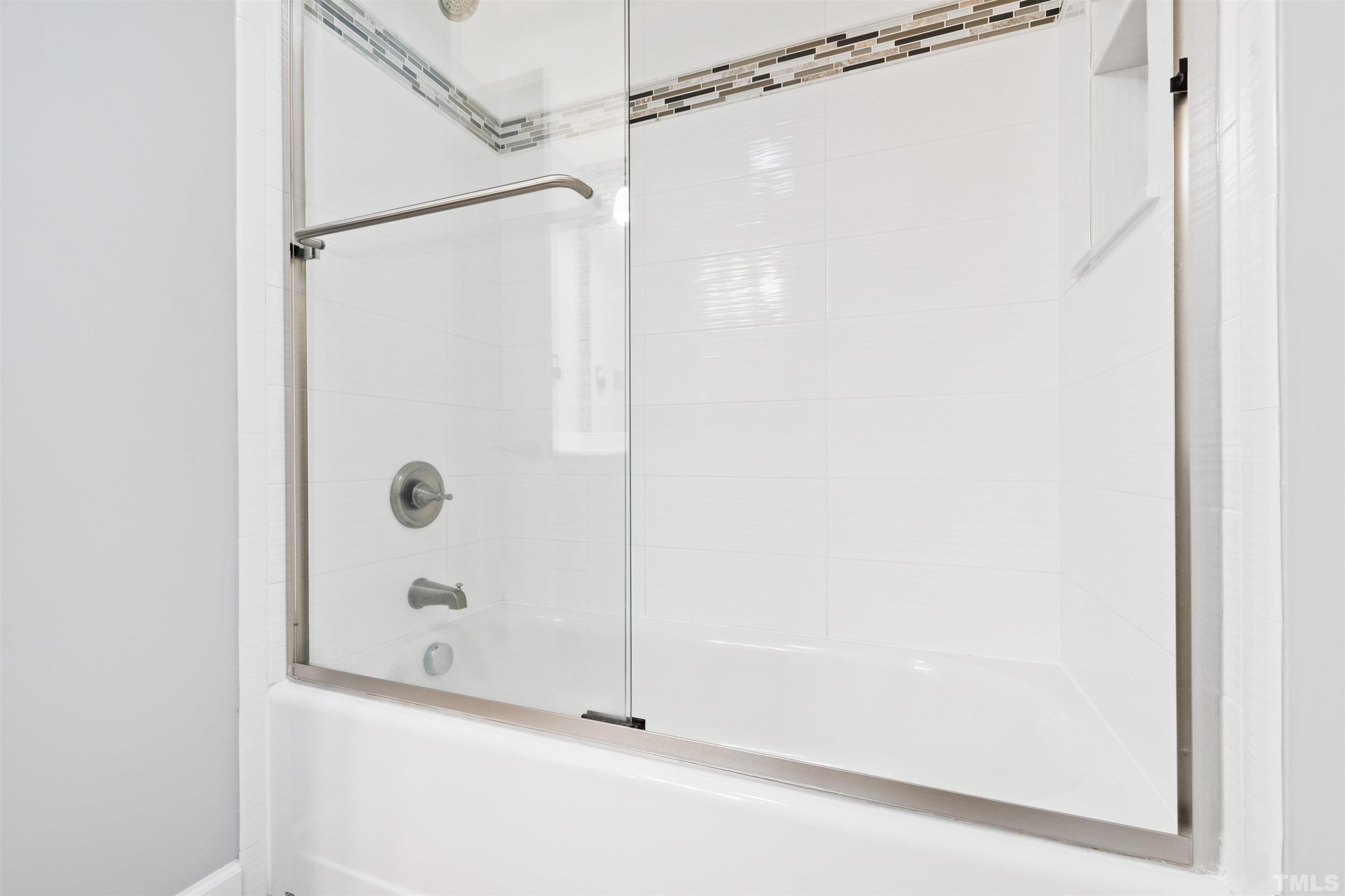 1320 Diehl Street Raleigh, NC 27608 - Photo 25 of 47 a bathroom with a glass shower door