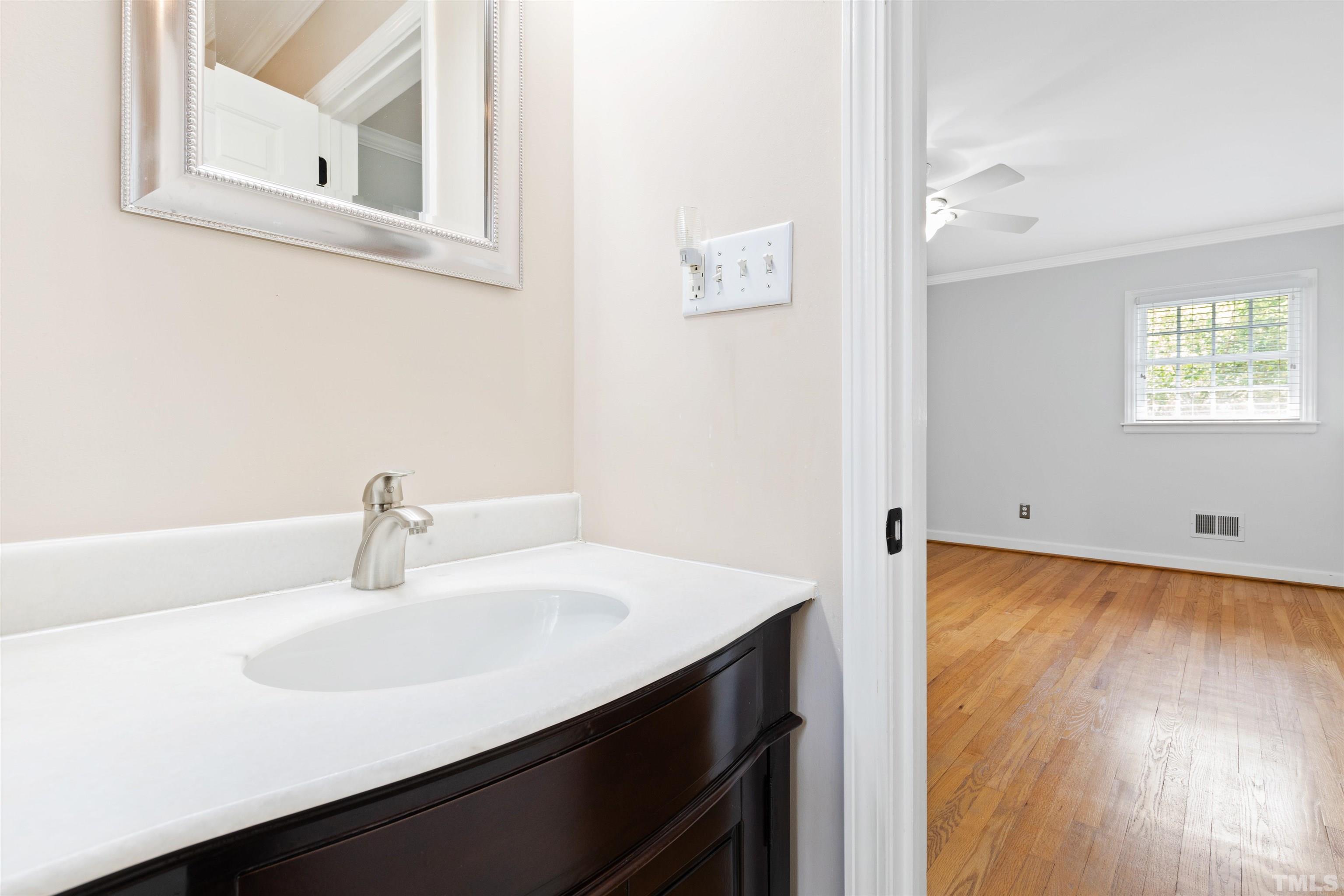 1320 Diehl Street Raleigh, NC 27608 - Photo 29 of 47 a bathroom with a sink and a mirror