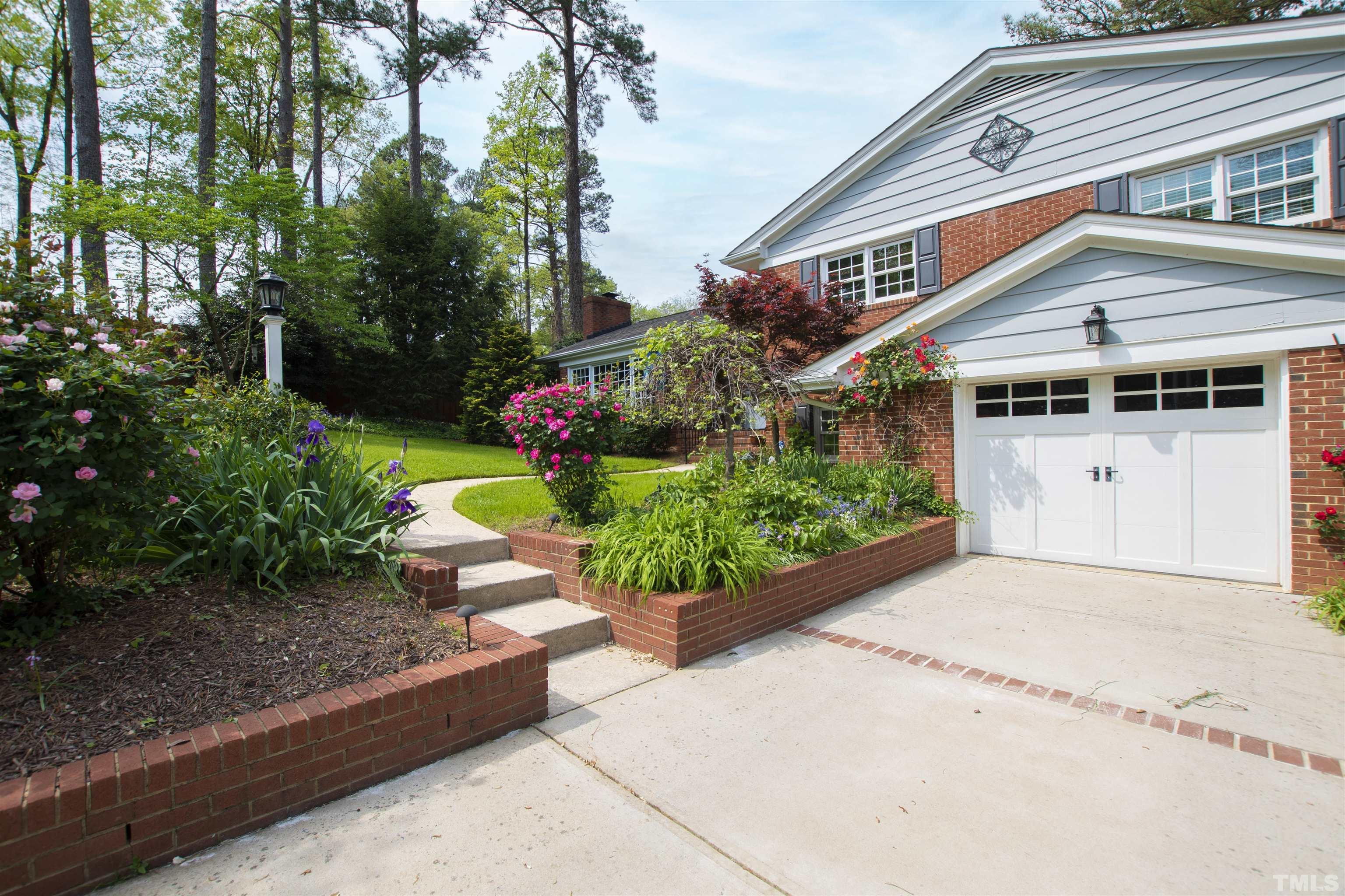 1320 Diehl Street Raleigh, NC 27608 - Photo 4 of 47 a front view of a house with a garden and a tree