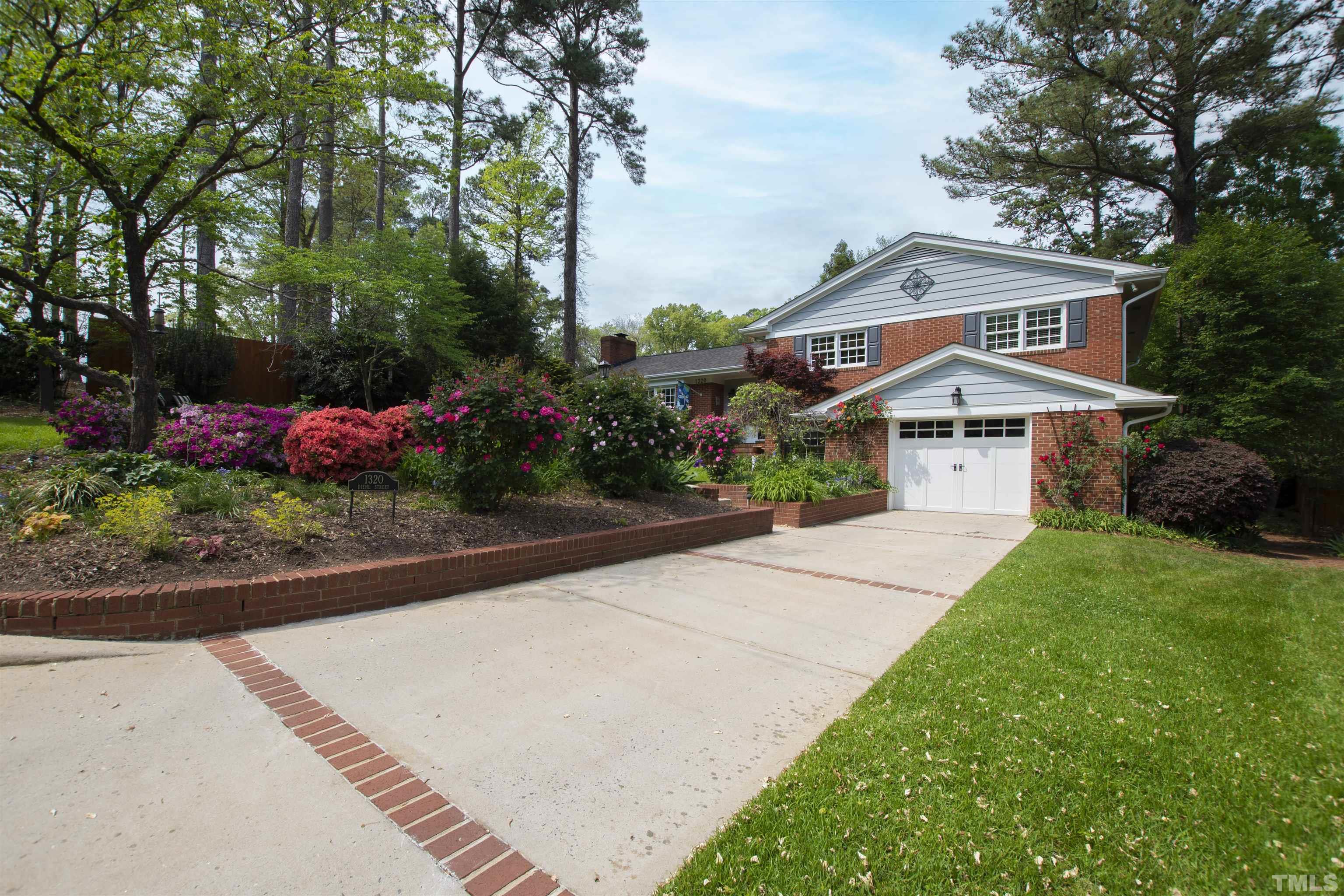 1320 Diehl Street Raleigh, NC 27608 - Photo 47 of 47 a front view of a house with a yard and fountain in middle
