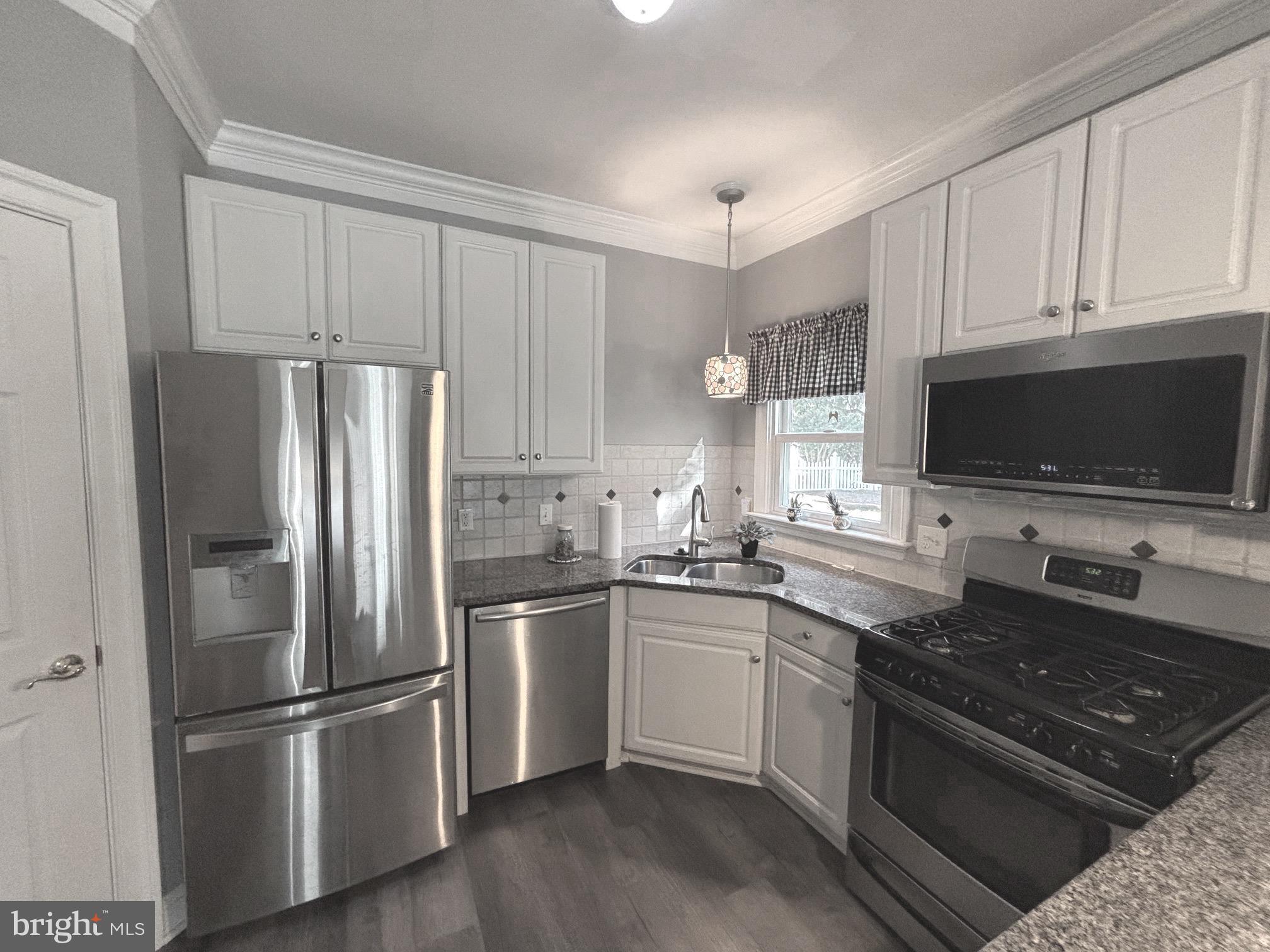 629 Country Club Road Culpeper, VA 22701 - Photo 4 of 27 a kitchen with stainless steel appliances a sink stove and refrigerator