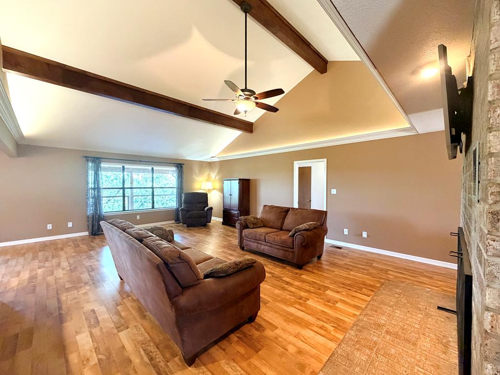 707 Rimrock Road Kerrville, TX 78028 - Photo 14 of 55 a living room with furniture a ceiling fan and a rug