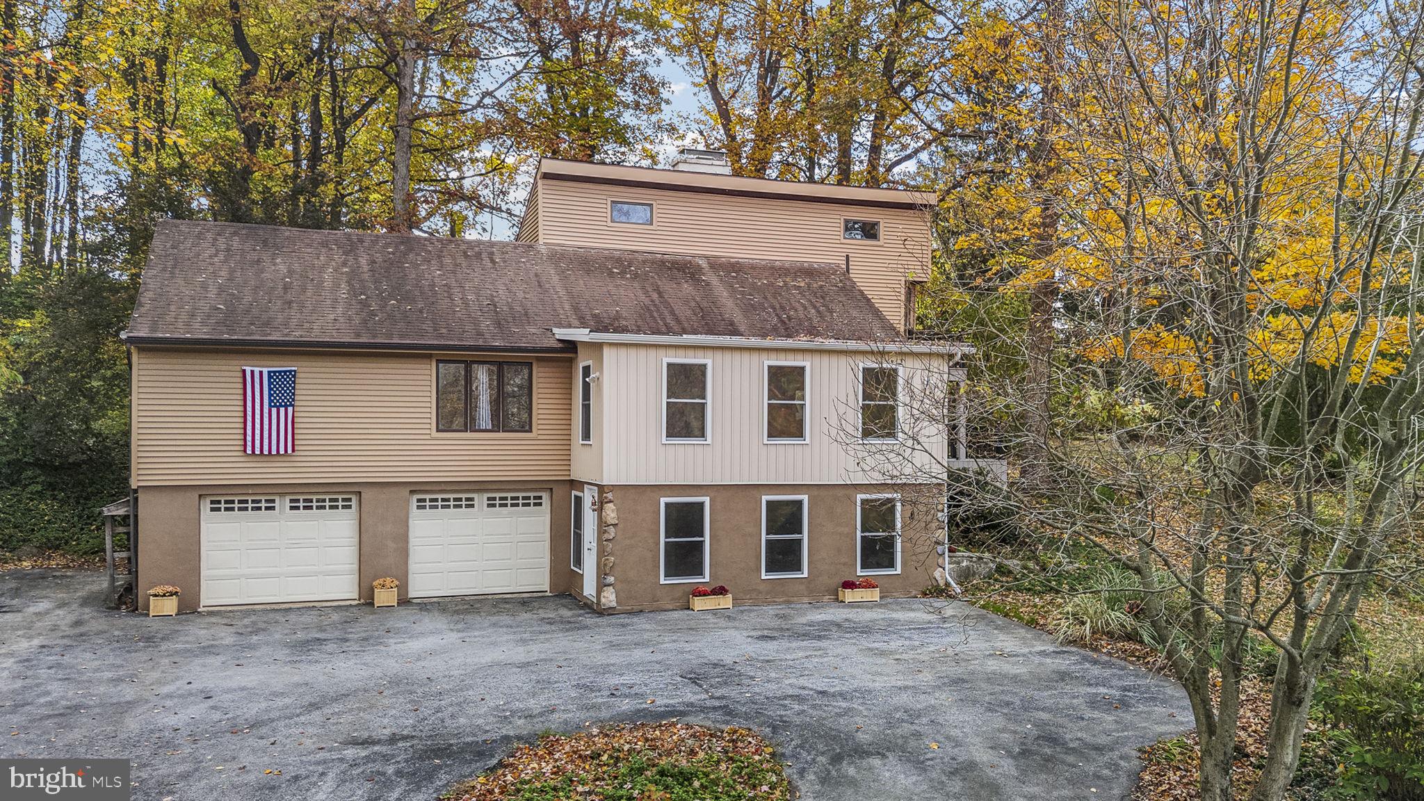 10 Woods Road Elverson, PA 19520 - Photo 2 of 49 a view of a house with a large tree and wooden fence