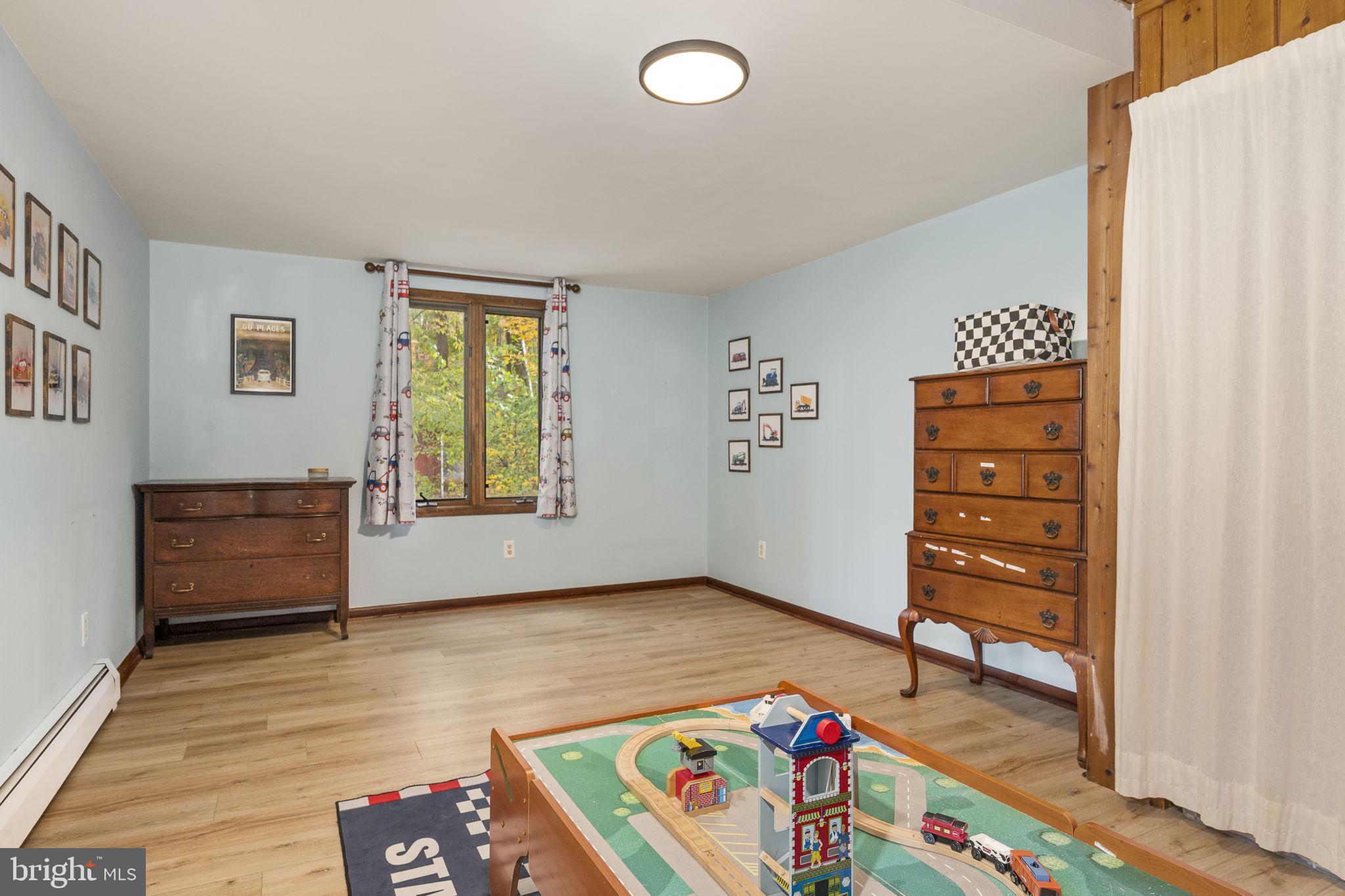 10 Woods Road Elverson, PA 19520 - Photo 36 of 49 an empty room with window and dresser