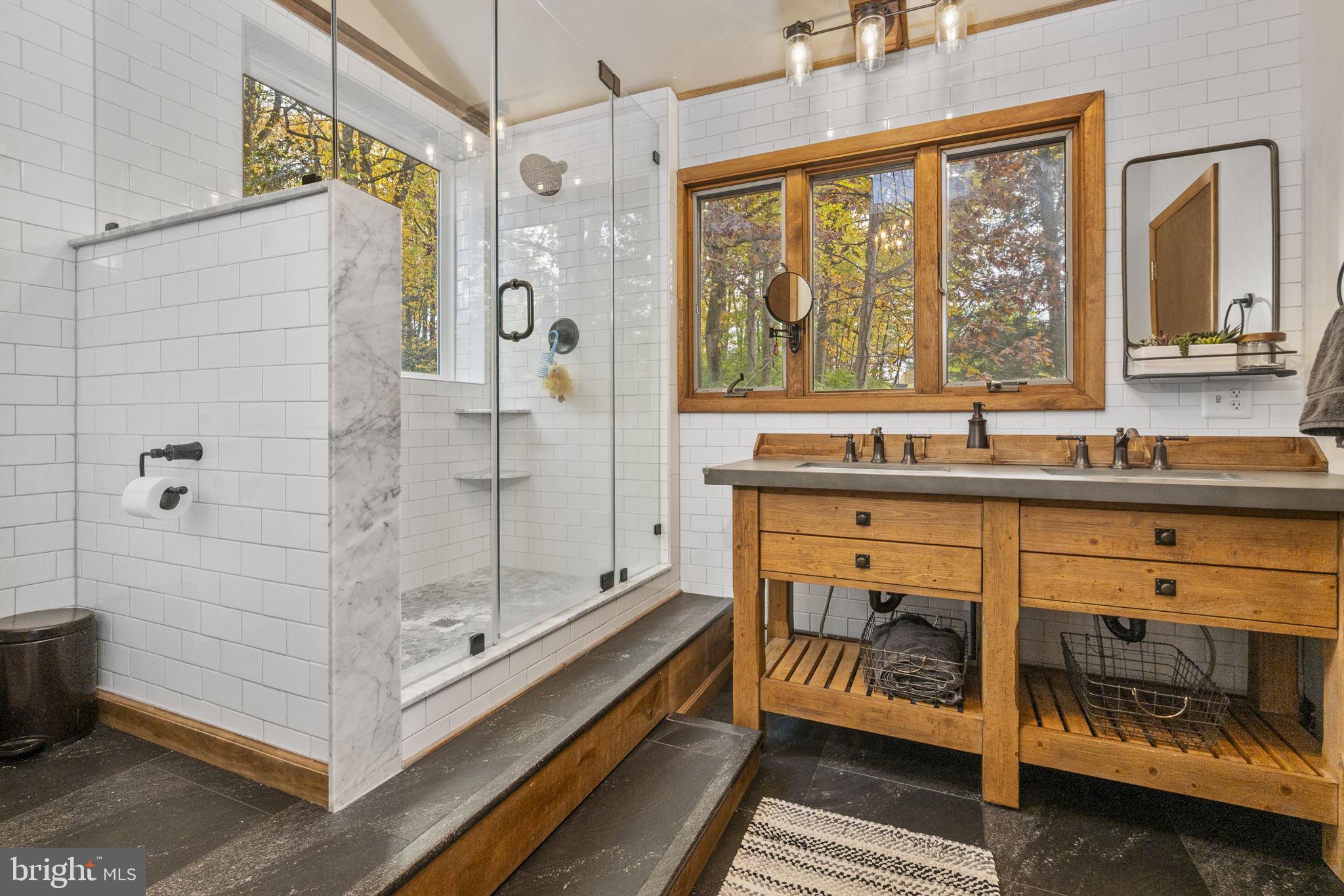 10 Woods Road Elverson, PA 19520 - Photo 45 of 49 a bathroom with a tub a sink and a large window