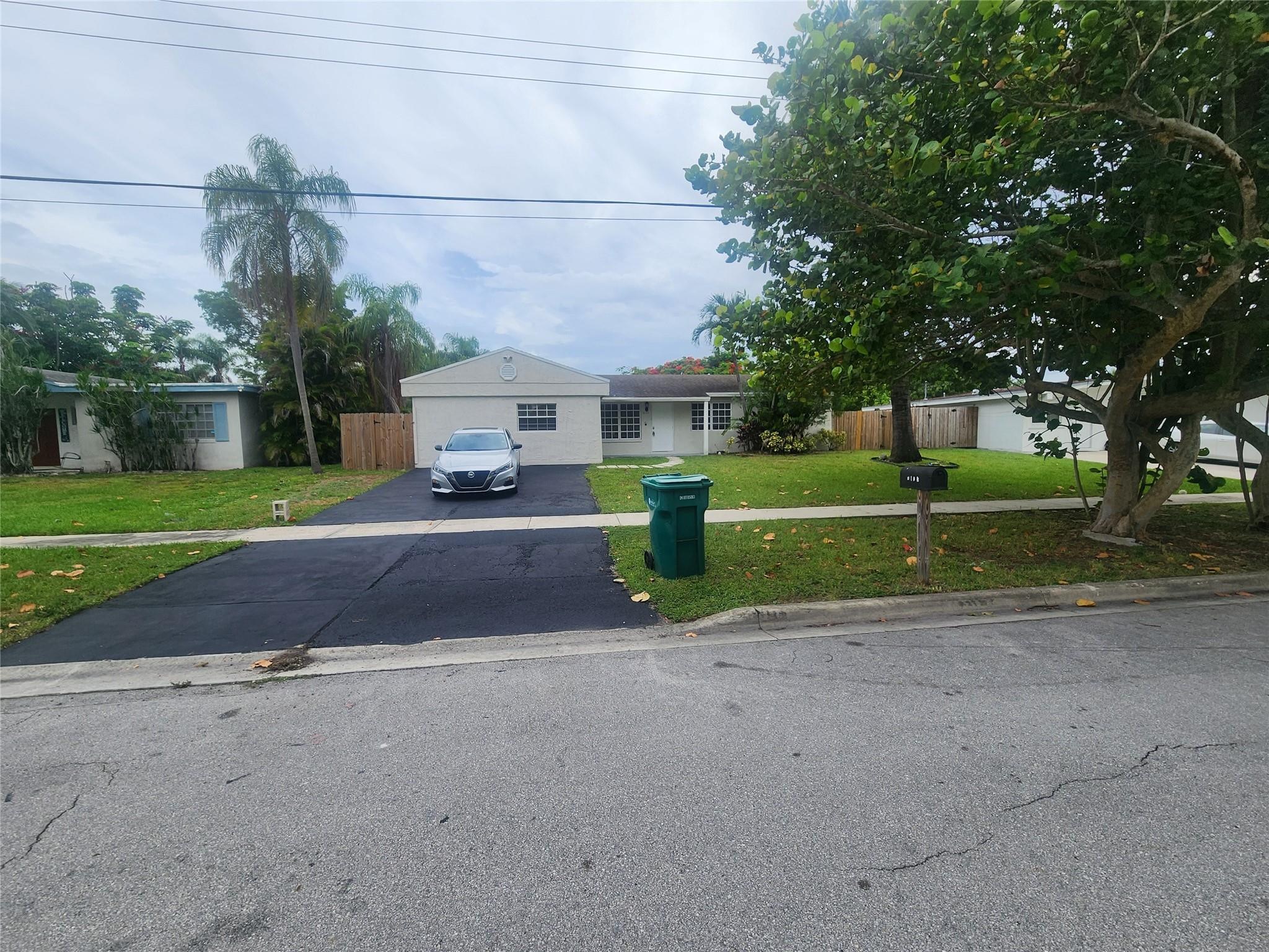 6133 Hogan Creek Road Margate, FL 33063 - Photo 1 of 5 a front view of a house with a yard and garage