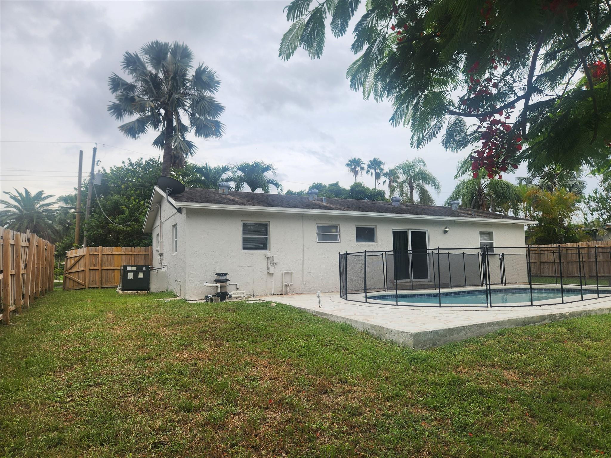 6133 Hogan Creek Road Margate, FL 33063 - Photo 5 of 5 a house with trees in the background