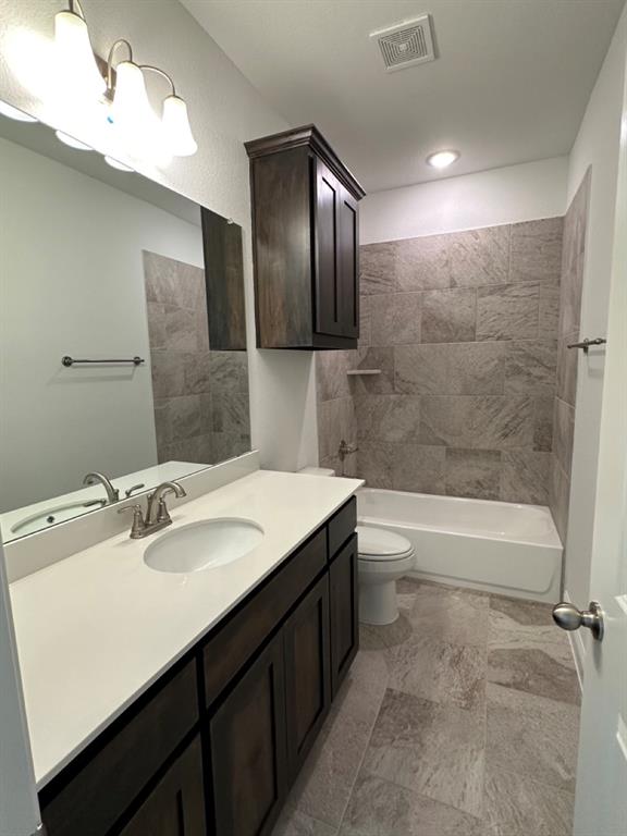 418 South 2nd Street Krum, TX 76249 - Photo 6 of 17 a bathroom with a bathtub sink vanity and mirror