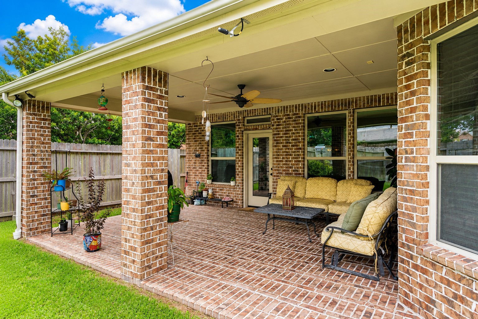2326 Hamilton Pool Lane Friendswood, TX 77546 - Photo 39 of 49 a view of a patio with table and chairs potted plants with wooden floor