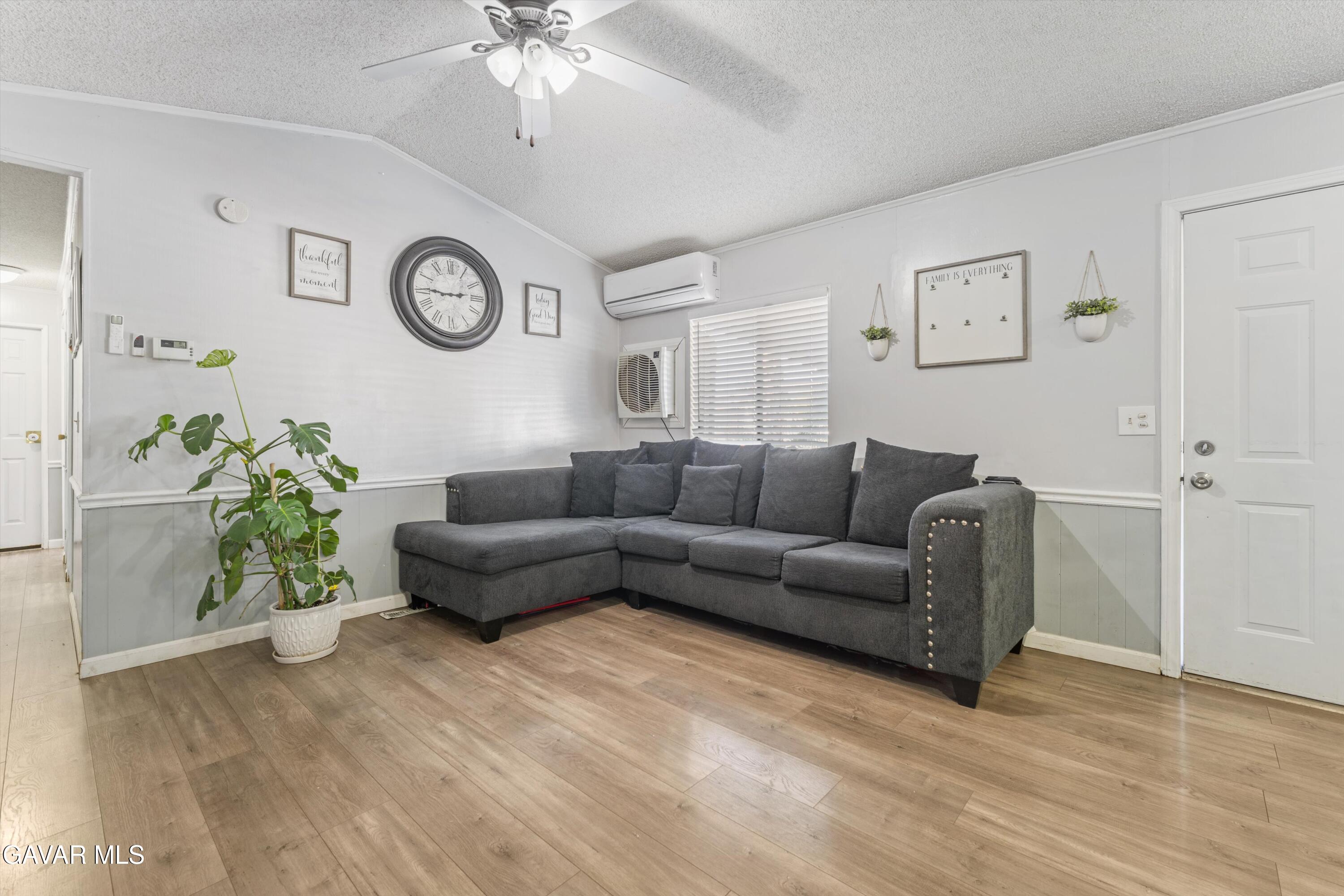 5711 Columbia Way Lancaster, CA 93536 - Photo 17 of 21 a living room with furniture and a chandelier
