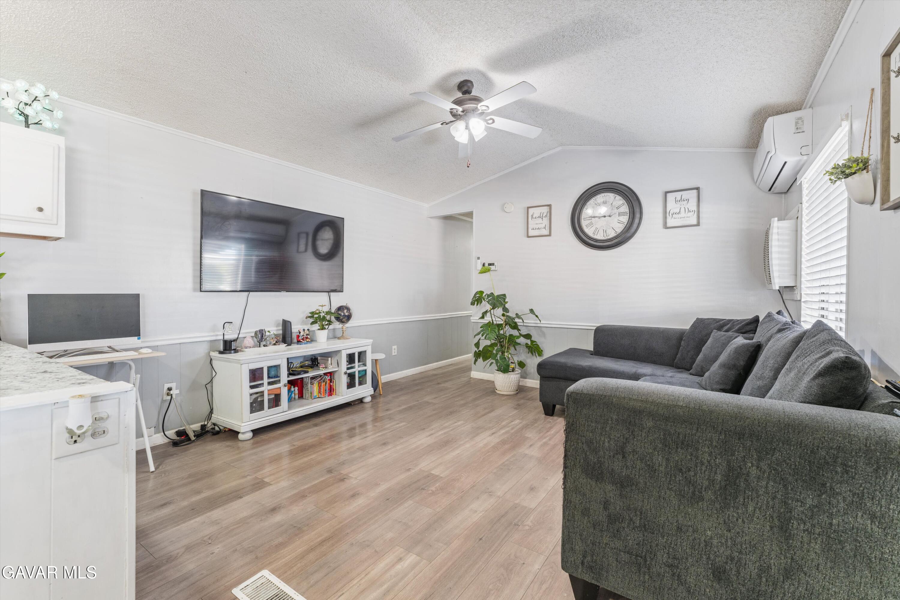 5711 Columbia Way Lancaster, CA 93536 - Photo 18 of 21 a living room with furniture and a flat screen tv