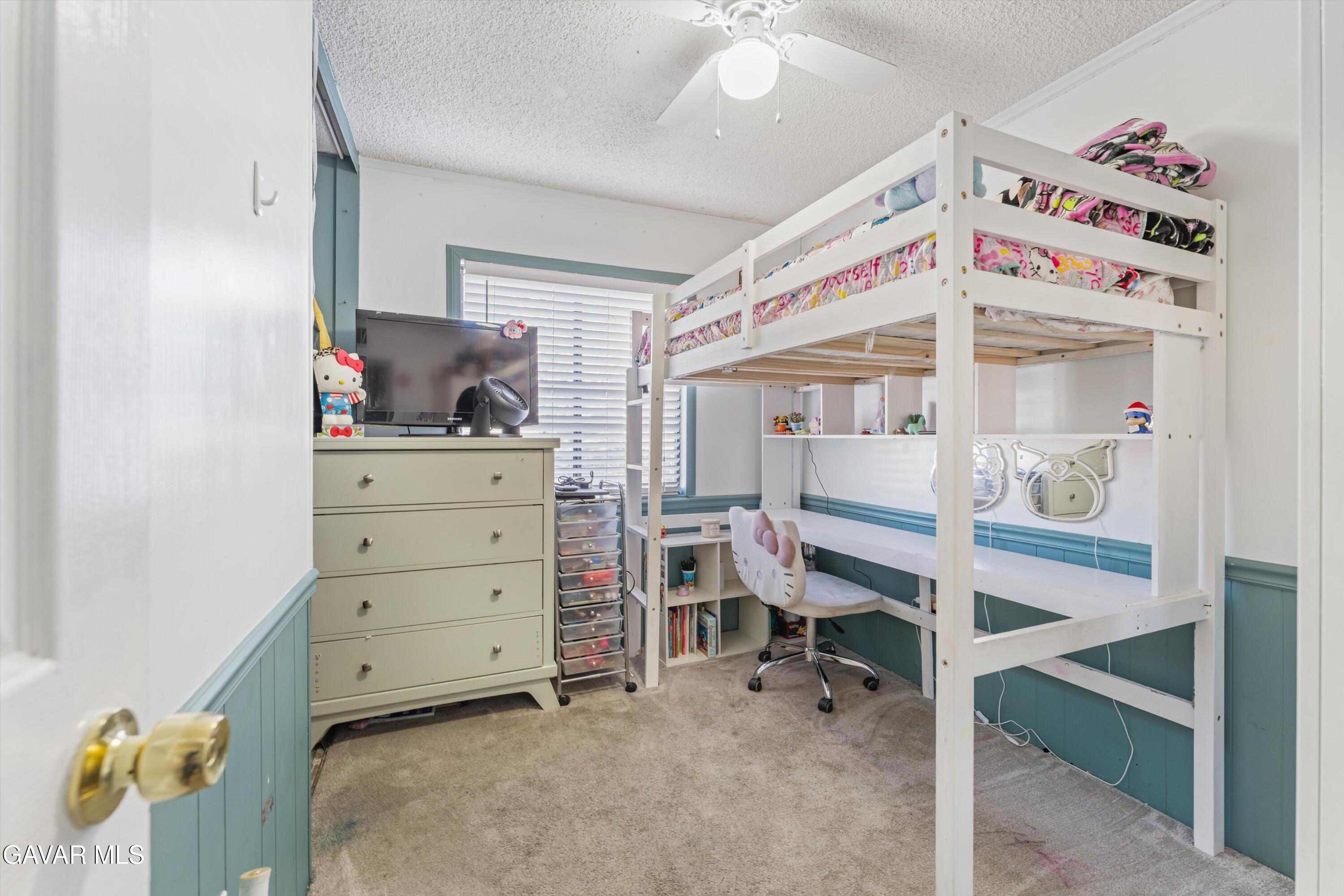 5711 Columbia Way Lancaster, CA 93536 - Photo 7 of 21 a bedroom with a bunk bed and a dresser
