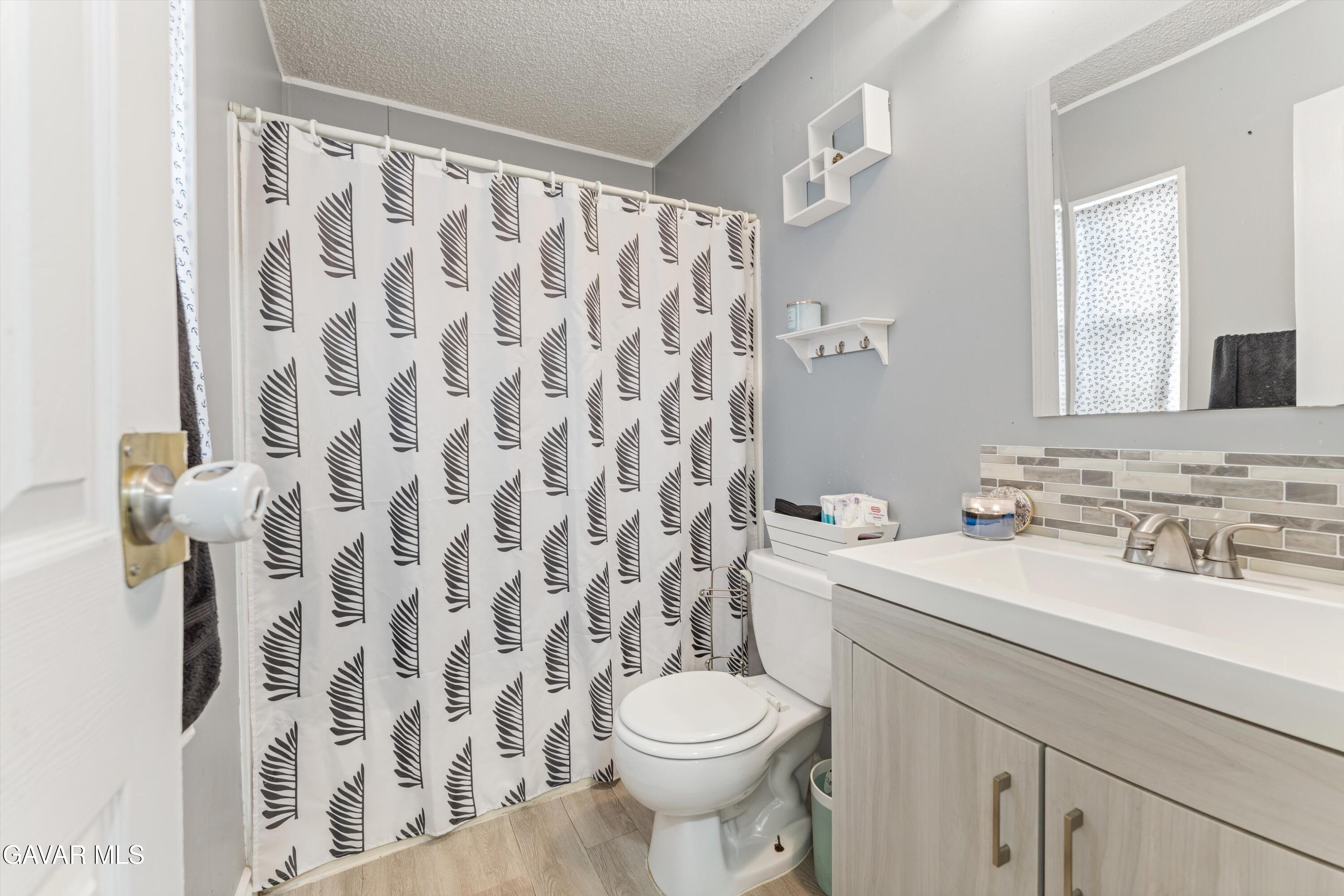 5711 Columbia Way Lancaster, CA 93536 - Photo 8 of 21 a bathroom with a sink and a toilet