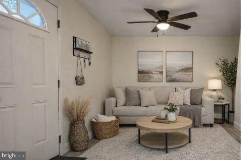 790 South Front Street, Unit R1 Philadelphia, PA 19147 - Photo 3 of 8 a living room with furniture and a wooden floor