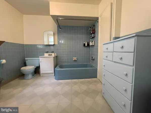 a bathroom with a bathtub a toilet and a shower