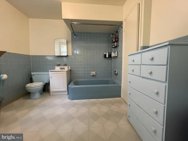 a bathroom with a bathtub a toilet and a shower