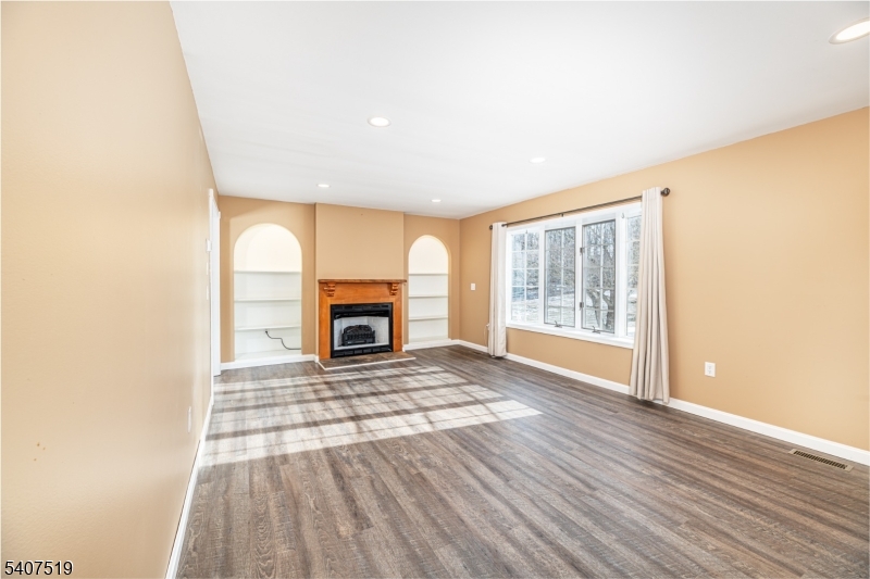 33 Hibler Road Newton, NJ 07860 - Photo 6 of 33 a view of empty room with wooden floor and fireplace