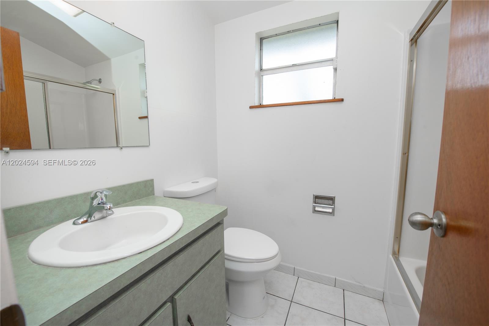 17355 Southwest 256th Street Homestead, FL 33031 - Photo 22 of 32 a bathroom with a sink toilet and a mirror