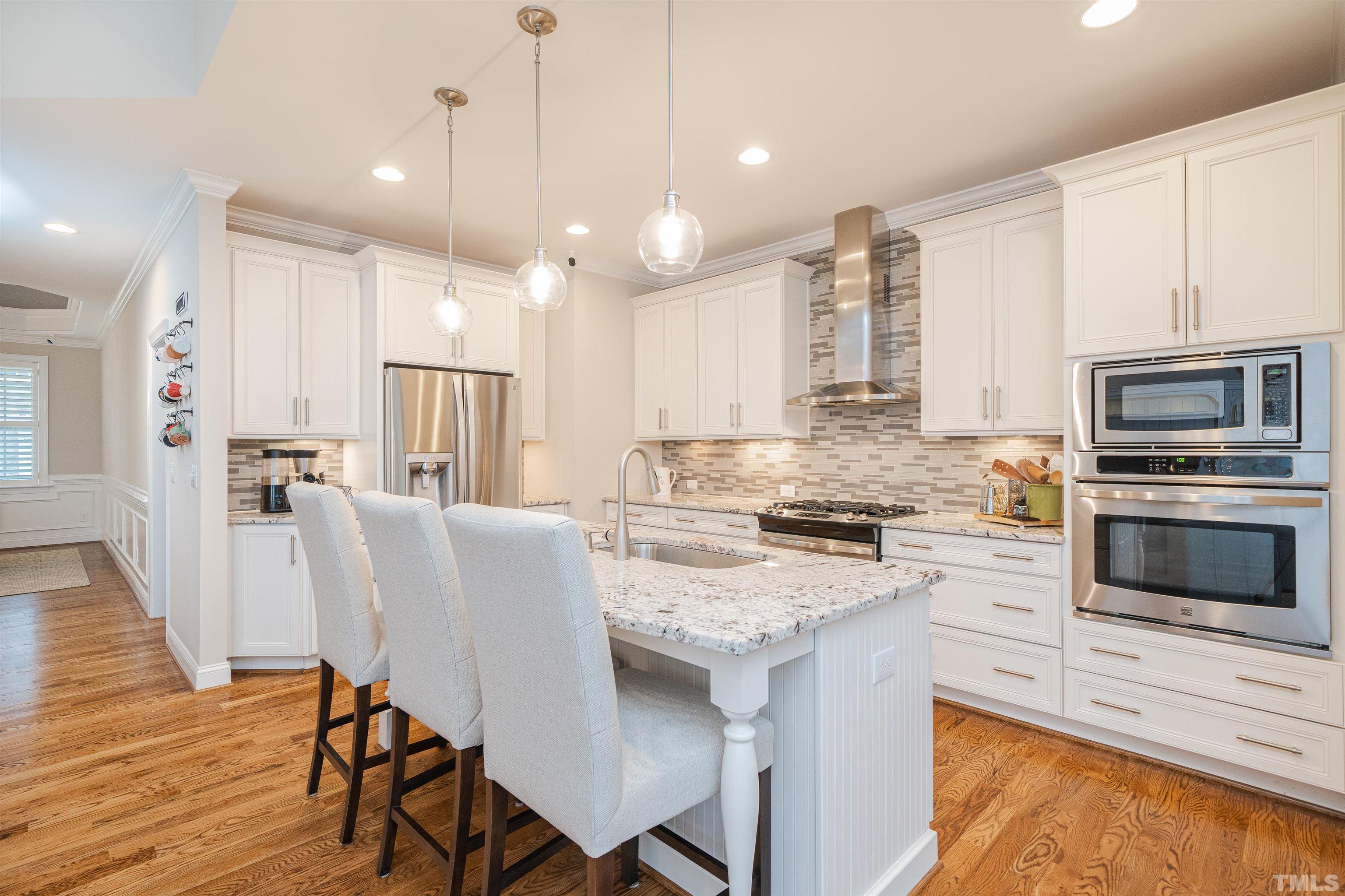 616 Connington Way Rolesville, NC 27571 - Photo 16 of 51 a kitchen with a table chairs microwave and cabinets