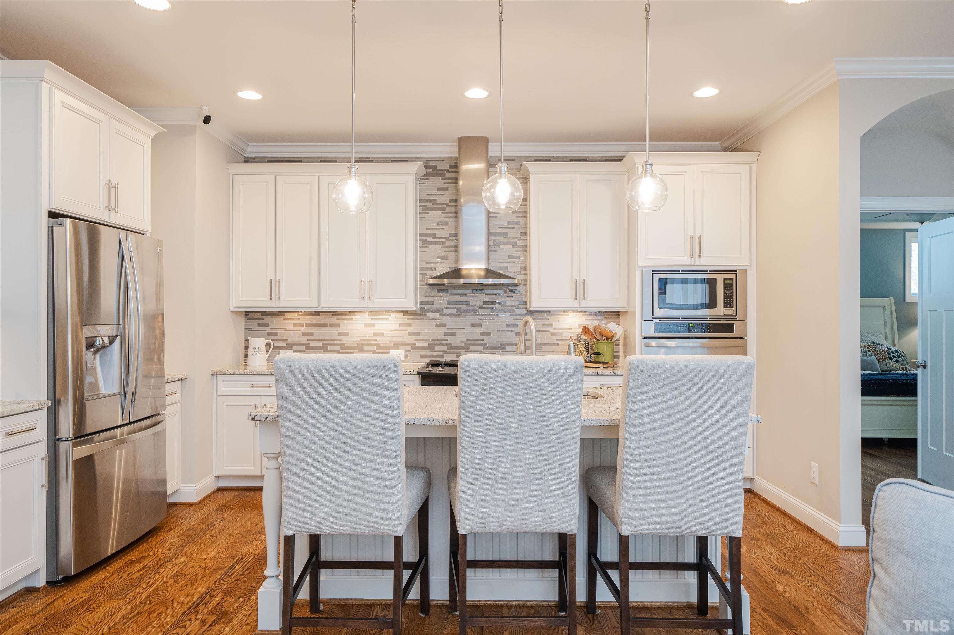 616 Connington Way Rolesville, NC 27571 - Photo 17 of 51 a kitchen with kitchen island granite countertop a refrigerator and a stove top oven