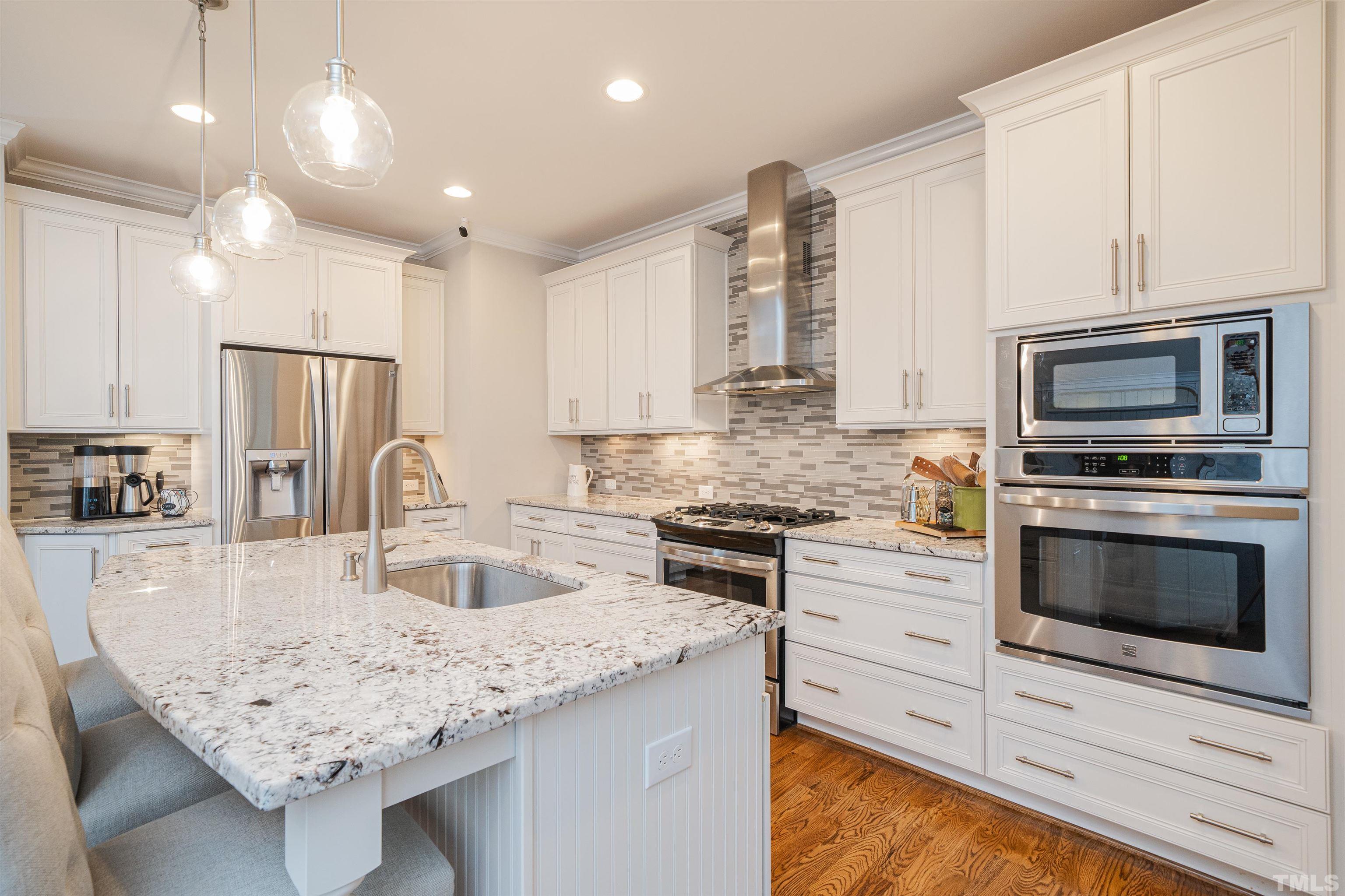 616 Connington Way Rolesville, NC 27571 - Photo 19 of 51 a kitchen with granite countertop a sink stove and refrigerator