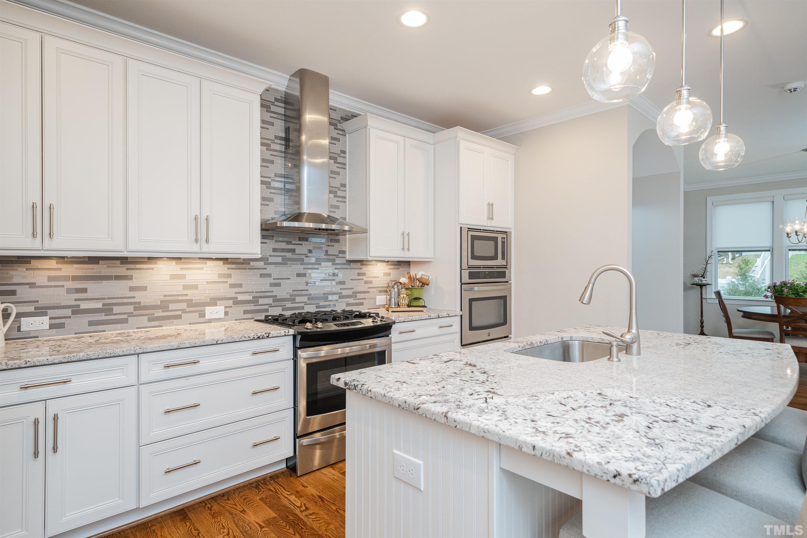 616 Connington Way Rolesville, NC 27571 - Photo 21 of 51 a kitchen with granite countertop a sink stainless steel appliances and white cabinets