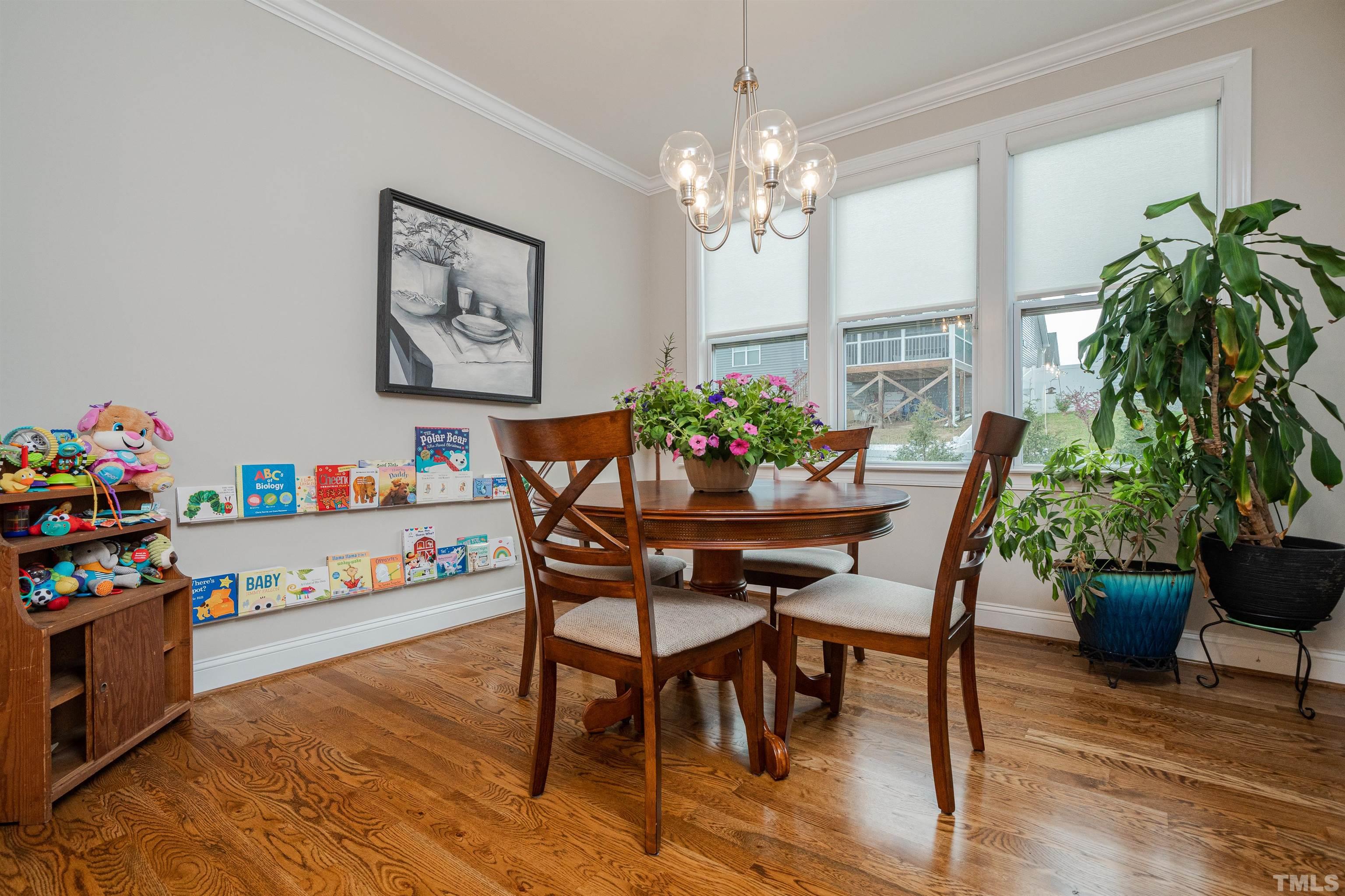 616 Connington Way Rolesville, NC 27571 - Photo 27 of 51 a dining room with furniture potted plants and wooden floor