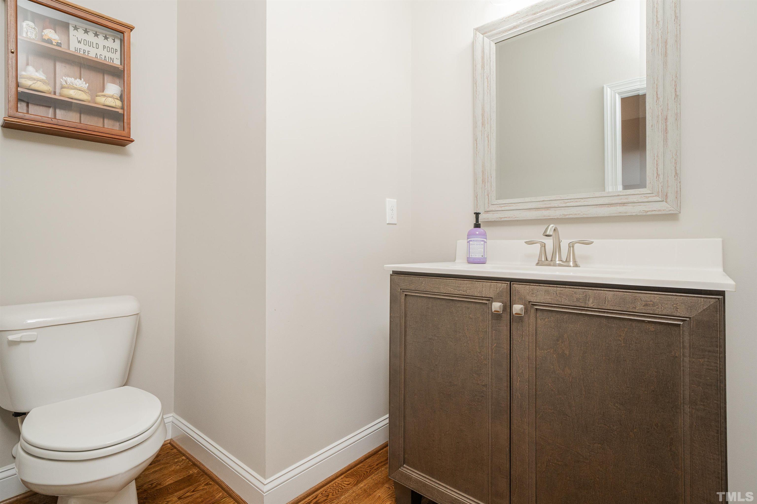 616 Connington Way Rolesville, NC 27571 - Photo 31 of 51 a bathroom with a toilet sink vanity and mirror