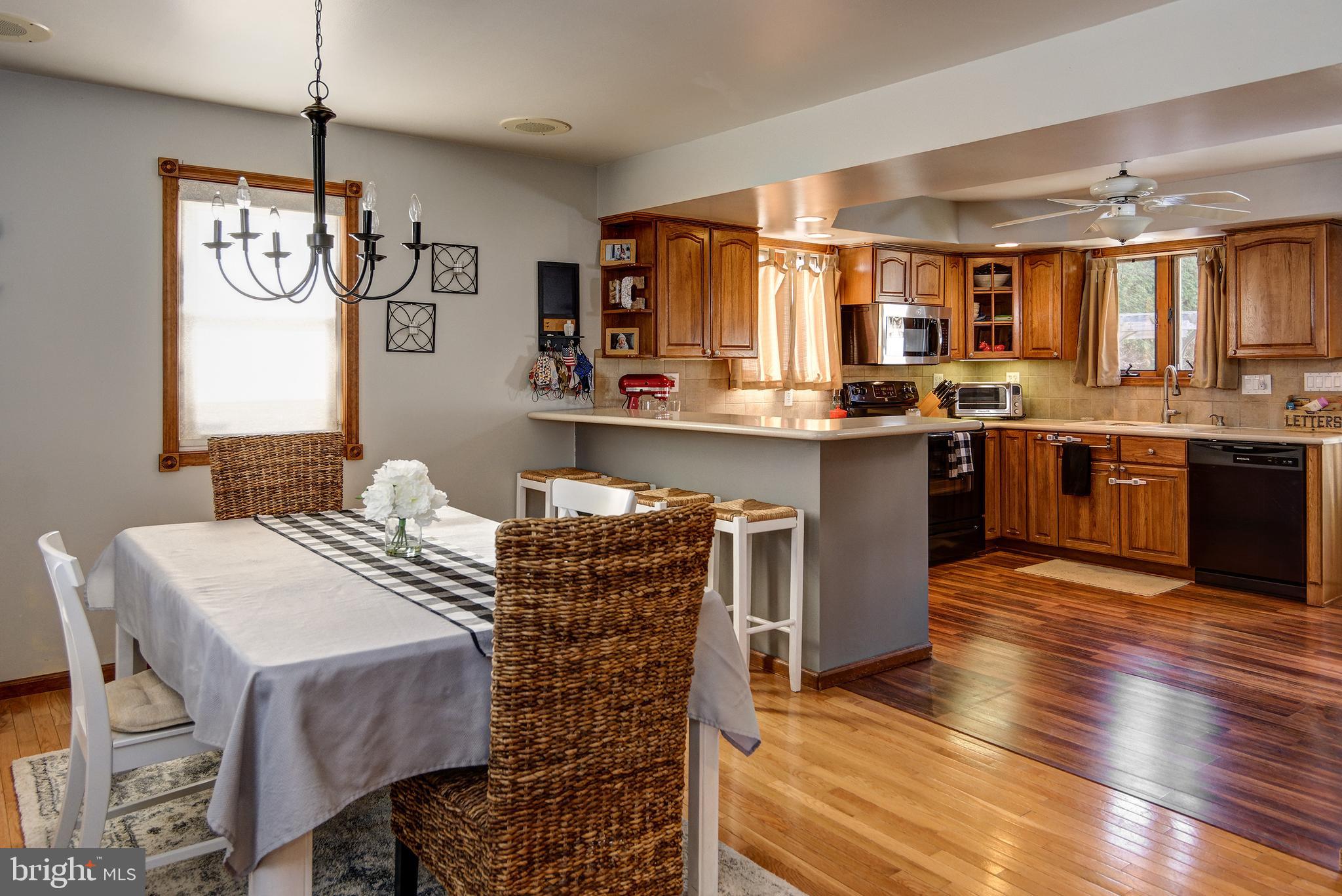 18 Sunset Road Blackwood, NJ 08012 - Photo 9 of 37 a kitchen with stainless steel appliances granite countertop a kitchen island hardwood floor sink stove dining table and chairs