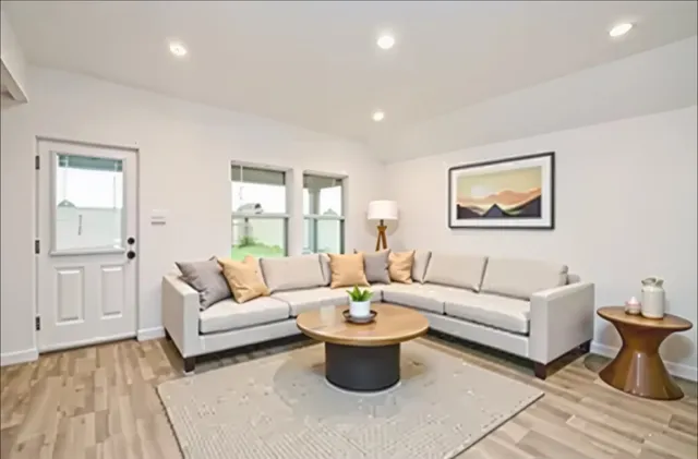 a living room with furniture and a painting on the wall