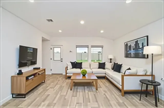 a living room with furniture and a flat screen tv