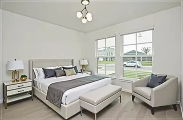 a spacious bedroom with a bed and a large window